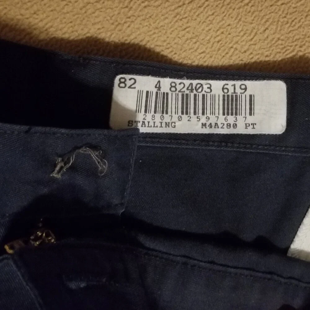 Three stained Cintas men's pants with stretching waistbands